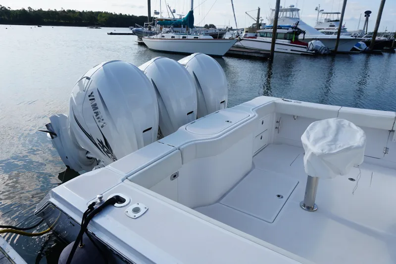 Slide: The Image of 2021 Jupiter 41 SB boat with triple Yamaha outboard engines docked at marina. - 10