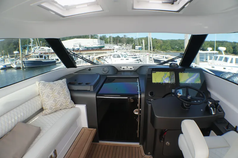 Slide: The Image of Interior view of 2021 Jupiter 41 SB yacht helm with navigation screens and seating. - 13