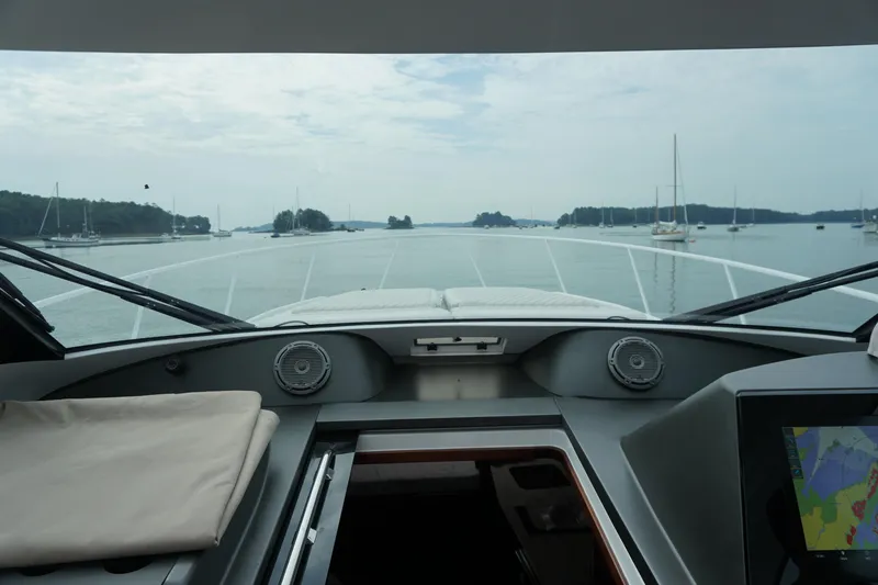 Slide: The Image of View from 2021 Jupiter 41 SB yacht cockpit, overlooking calm waters and anchored sailboats. - 19
