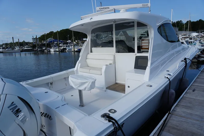 Slide: The Image of 2021 Jupiter 41 SB boat docked at marina with Yamaha engine. - 3