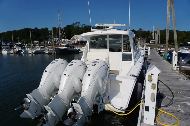 Slide: The Image of Jupiter 41 SB 2021 boat with four outboard engines at dock. - 6