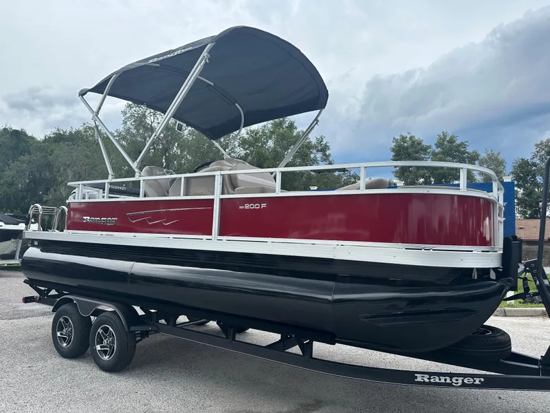 The Image of 2024 Ranger Reata 200F pontoon boat with canopy on trailer. - 0