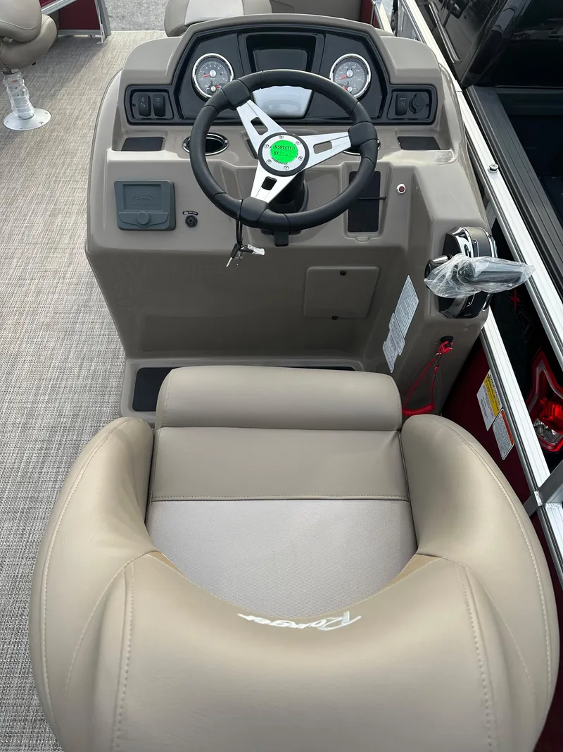 Slide: The Image of 2024 Ranger Reata 200F boat cockpit with steering wheel and captain's chair. - 10