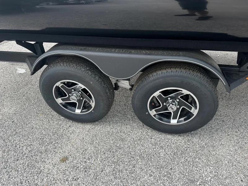 Slide: The Image of 2024 Ranger Reata 200F trailer wheels on asphalt. - 4