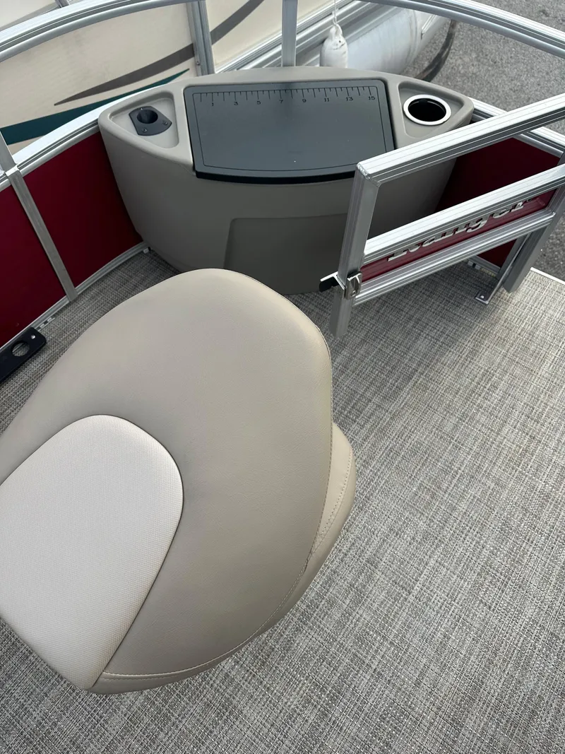 Slide: The Image of 2024 Ranger Reata 200F boat interior with beige seat and control panel. - 6
