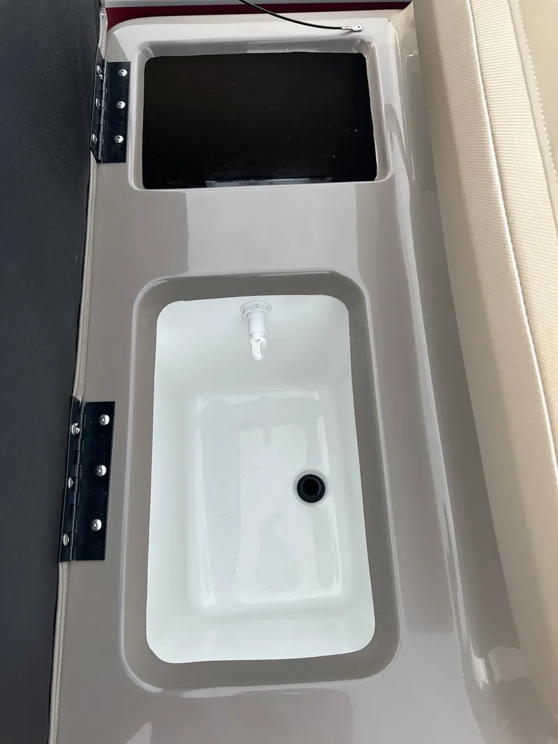 Slide: The Image of 2024 Ranger Reata 200F boat storage compartments and seating area. - 9