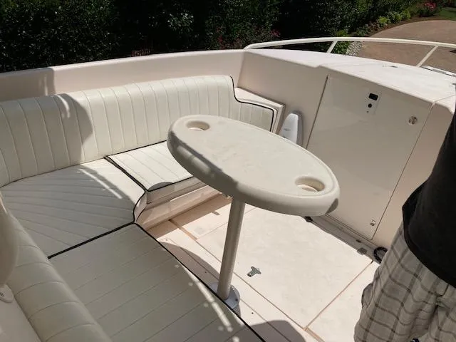 Slide: The Image of Interior of a 2002 Intrepid 322 boat with seating area and table. - 9