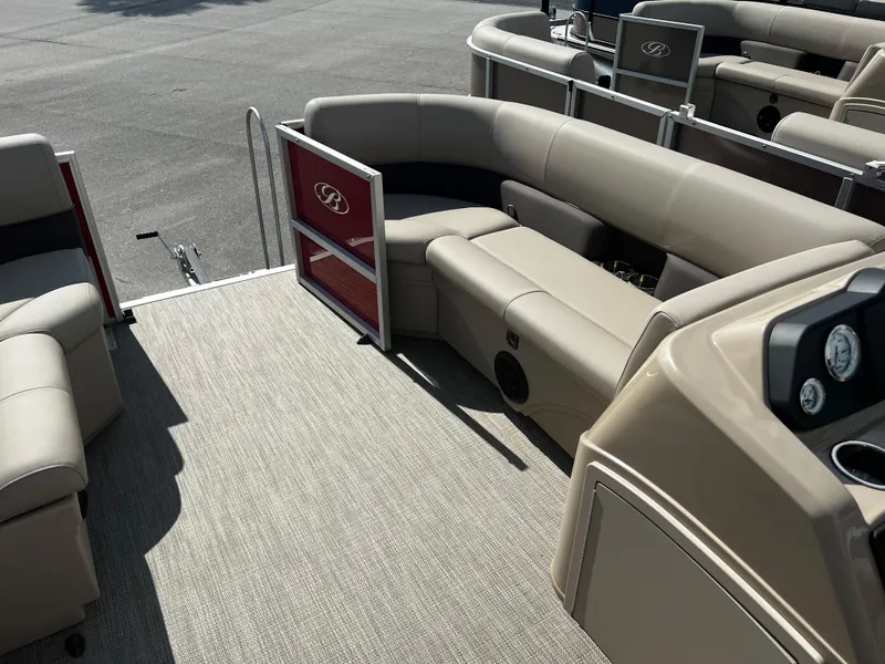 Slide: The Image of 2024 Bentley Pontoons LE 18 interior with beige seating and red accents. - 10