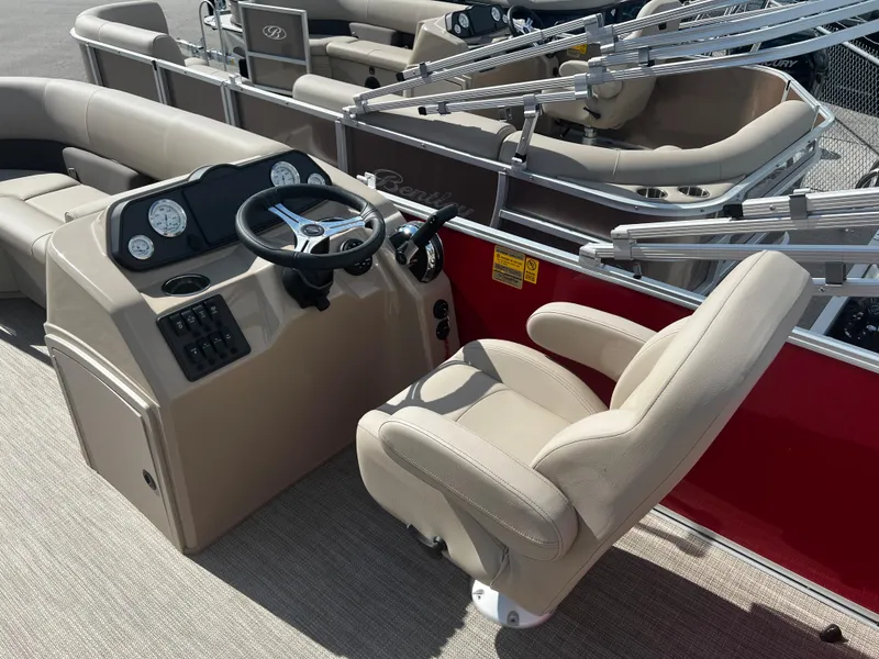 Slide: The Image of 2024 Bentley Pontoons LE 18 boat interior with captain's chair and control console. - 12
