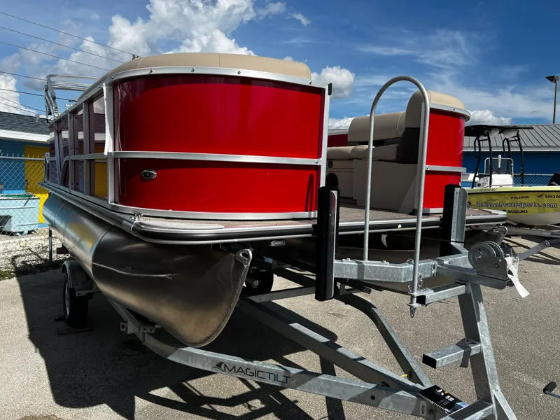Slide: The Image of 2024 Bentley Pontoons LE 18 in red on a trailer. - 2