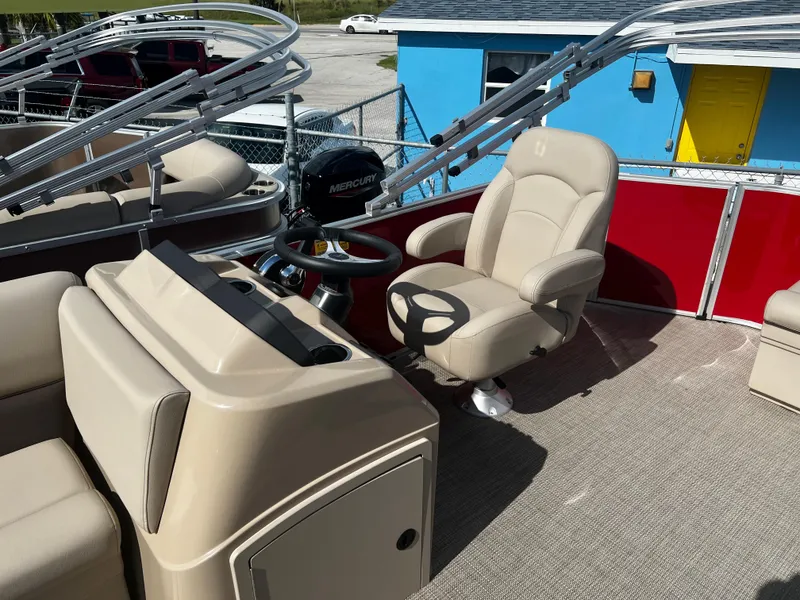 Slide: The Image of 2024 Bentley Pontoons LE 18 interior with beige captain's chair and steering console. - 8