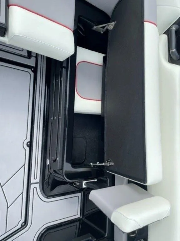 Slide: The Image of 2024 Moomba Craz boat interior storage compartment with white and black seating. - 10