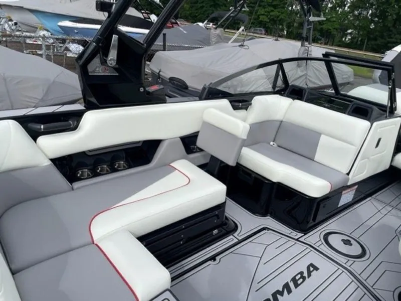 Slide: The Image of 2024 Moomba Craz boat interior with white and gray seating, black accents, and spacious layout. - 13