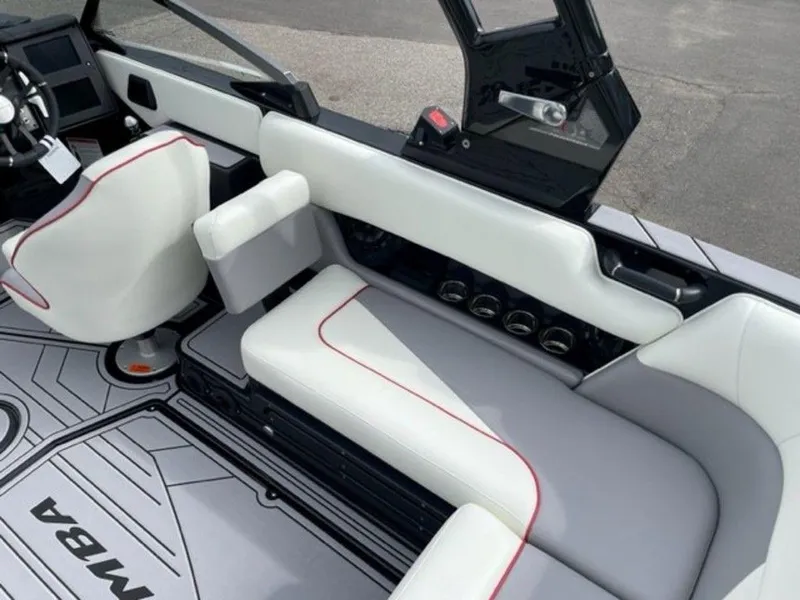 Slide: The Image of 2024 Moomba Craz boat interior with white and gray seating, red accents, and modern dashboard. - 16