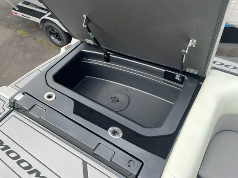 Slide: The Image of 2024 Moomba Craz boat storage compartment with open lid. - 17