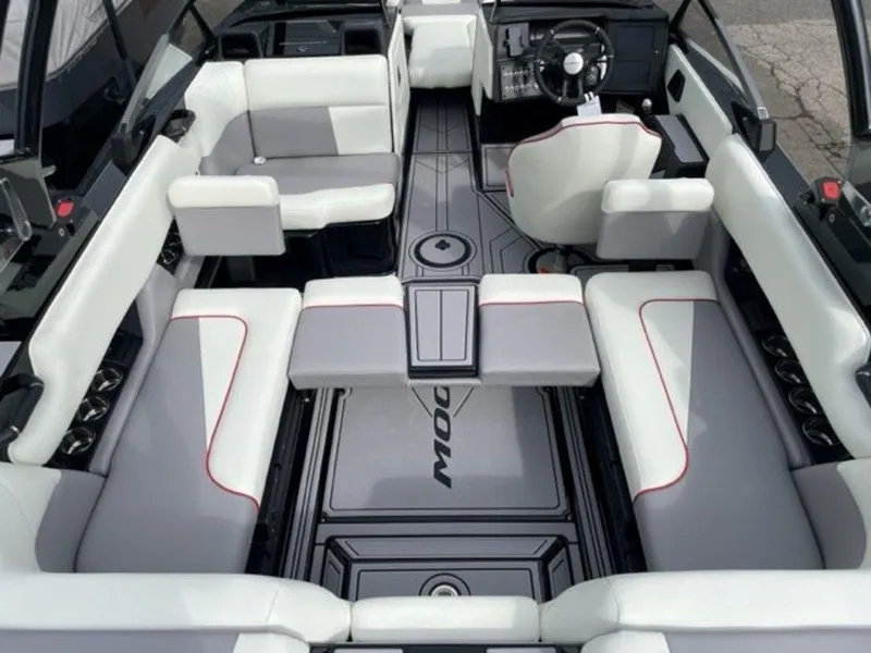 Slide: The Image of 2024 Moomba Craz boat interior with white and gray seating, red accents, and modern dashboard. - 21