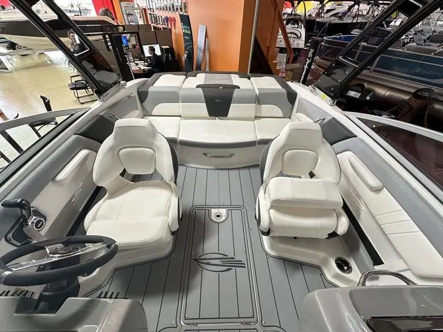 Slide: The Image of 2024 Chaparral 21 SSi boat interior with white seating and gray flooring. - 9