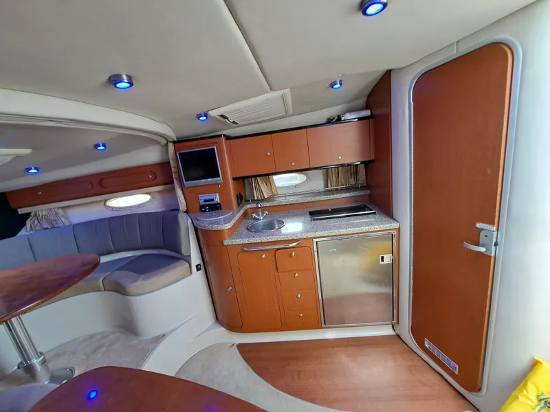 Slide: The Image of Interior of 2005 Chaparral 330 Signature Cruiser with kitchenette and seating area. - 14