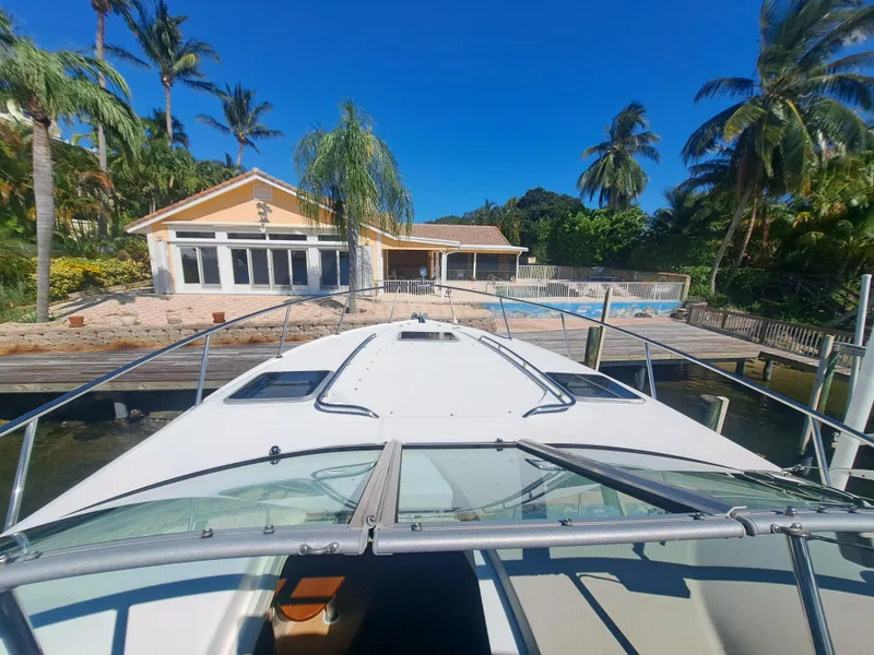Slide: The Image of 2005 Chaparral 330 Signature Cruiser docked at a tropical waterfront home. - 4