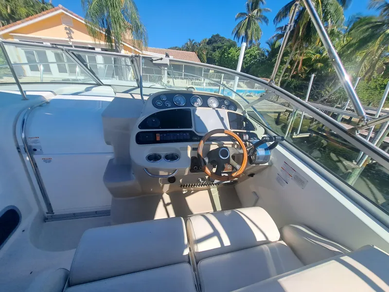 Slide: The Image of 2005 Chaparral 330 Signature Cruiser helm with steering wheel and control panel. - 5