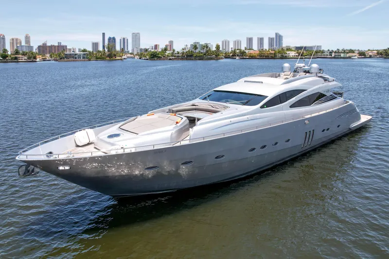Slide: The Image of 2007 Pershing 90 yacht cruising on a calm waterway with city skyline in the background. - 12