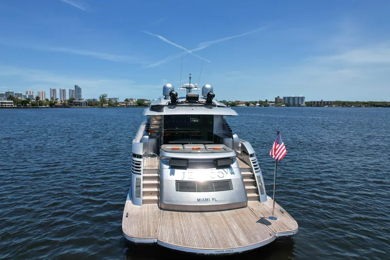 Slide: The Image of Luxury 2007 Pershing 90 yacht docked on calm waters with city skyline in background. - 15