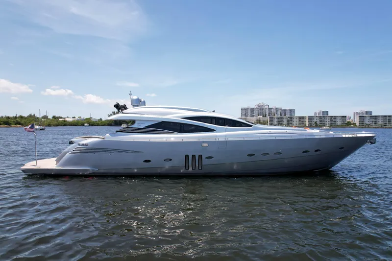 Slide: The Image of 2007 Pershing 90 yacht on calm water with cityscape background. - 2