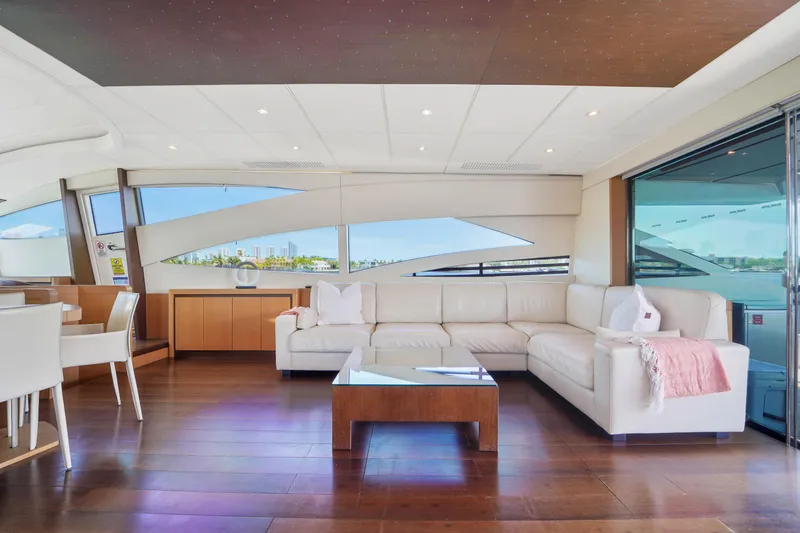 Slide: The Image of Luxurious interior of a 2007 Pershing 90 yacht with white leather seating and wooden flooring. - 26