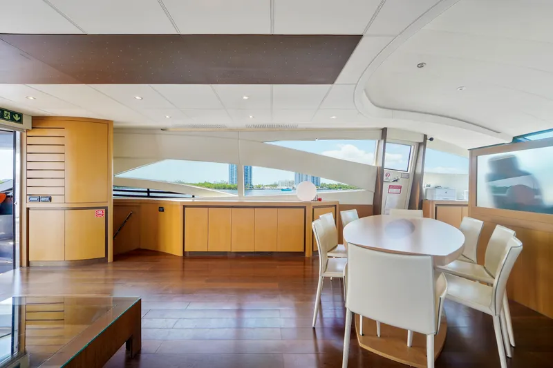 Slide: The Image of Interior of 2007 Pershing 90 yacht with modern dining area and panoramic windows. - 27