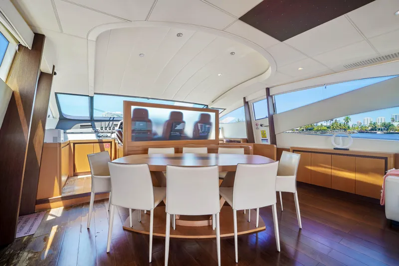 Slide: The Image of Luxurious interior of a 2007 Pershing 90 yacht with modern dining area. - 28