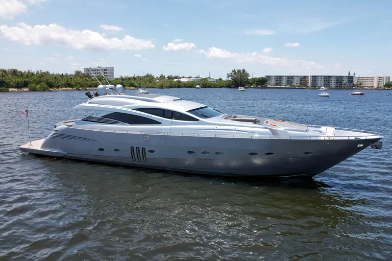 Slide: The Image of 2007 Pershing 90 yacht on calm water with buildings in the background. - 3
