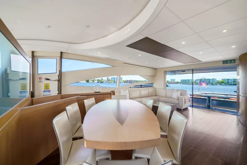 Slide: The Image of Luxurious interior of a 2007 Pershing 90 yacht with dining area and scenic windows. - 30