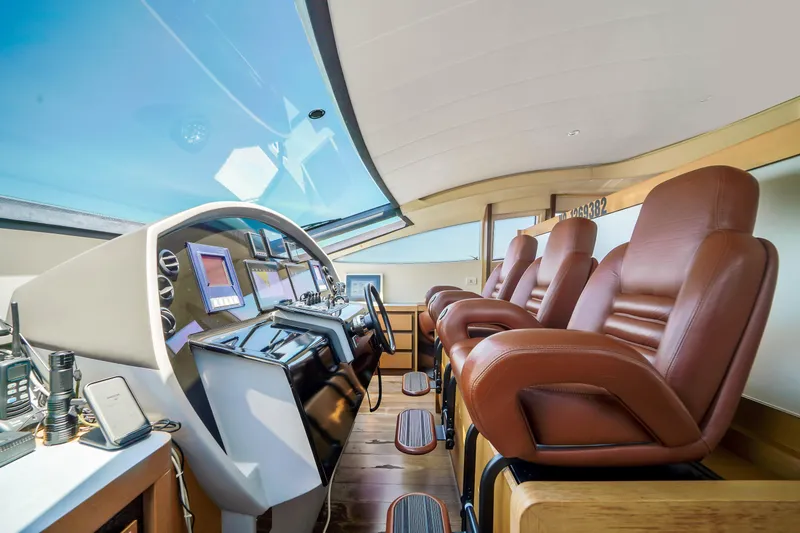 Slide: The Image of Luxurious cockpit of 2007 Pershing 90 yacht with leather seats and advanced navigation systems. - 31