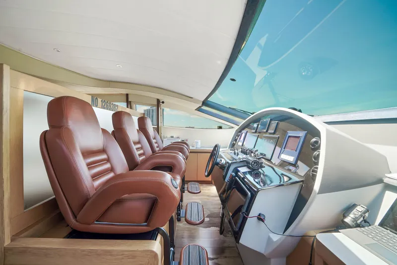Slide: The Image of Luxurious cockpit of a 2007 Pershing 90 yacht with leather seats and advanced navigation systems. - 32
