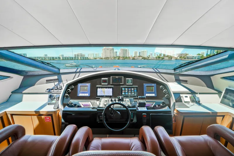 Slide: The Image of Cockpit of a 2007 Pershing 90 yacht with modern navigation equipment and panoramic view. - 34