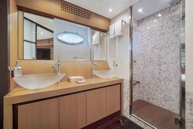 Slide: The Image of Luxury bathroom in 2007 Pershing 90 yacht with dual sinks and glass shower. - 40