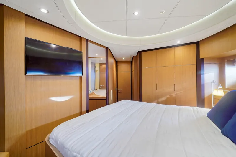 Slide: The Image of Luxurious bedroom on a 2007 Pershing 90 yacht with modern wood paneling. - 43
