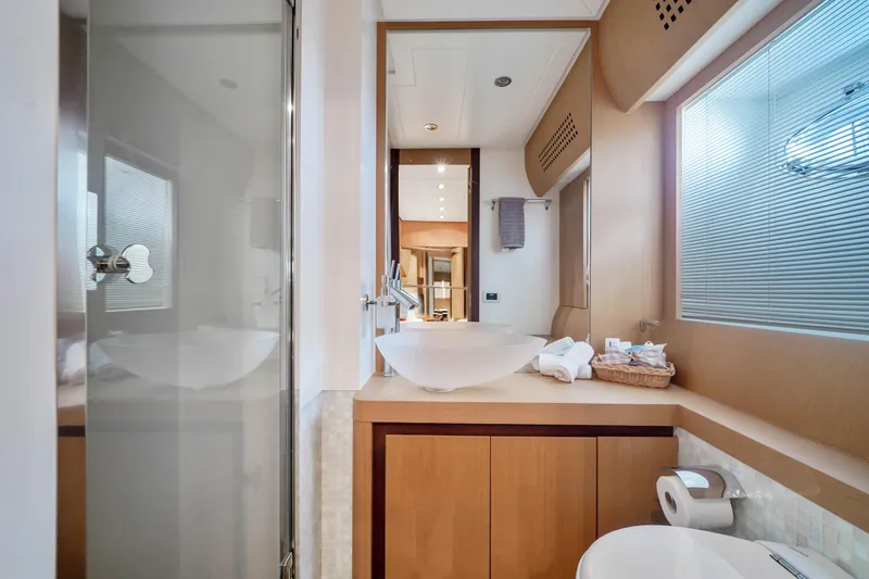 Slide: The Image of Luxurious bathroom on a 2007 Pershing 90 yacht with modern fixtures and wooden cabinetry. - 44