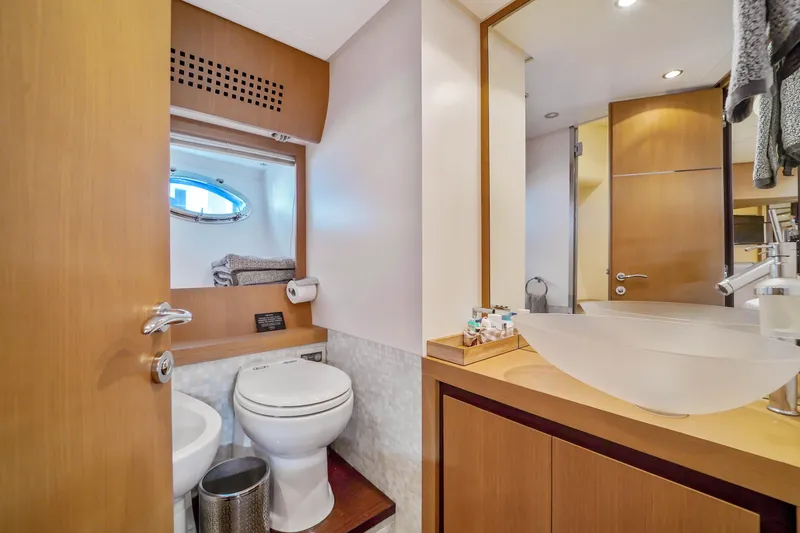 Slide: The Image of Luxurious bathroom on a 2007 Pershing 90 yacht with modern fixtures and wooden cabinetry. - 45