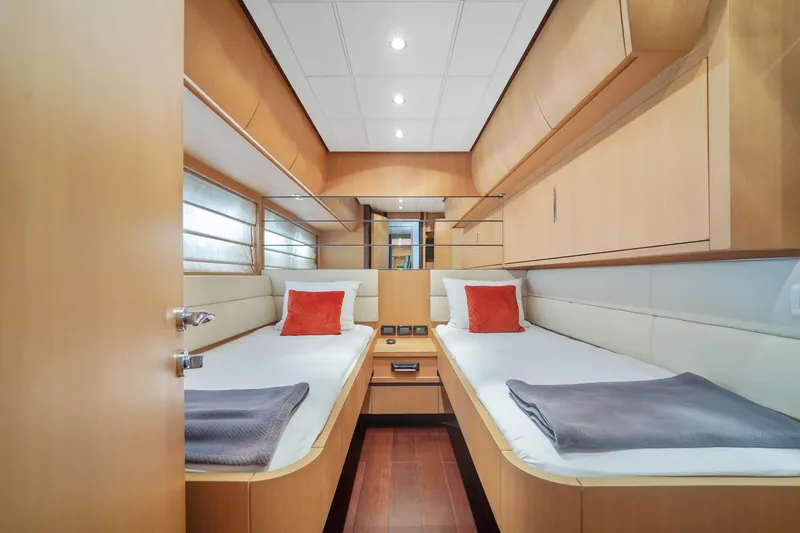 Slide: The Image of 2007 Pershing 90 yacht twin cabin with modern wood finish and cozy bedding. - 46