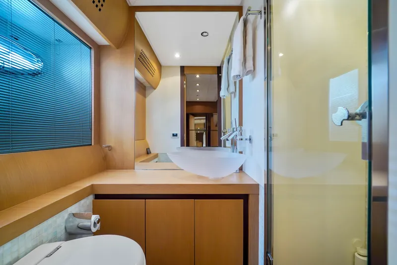 Slide: The Image of Modern bathroom in a 2007 Pershing 90 yacht with sleek fixtures and wooden cabinetry. - 47