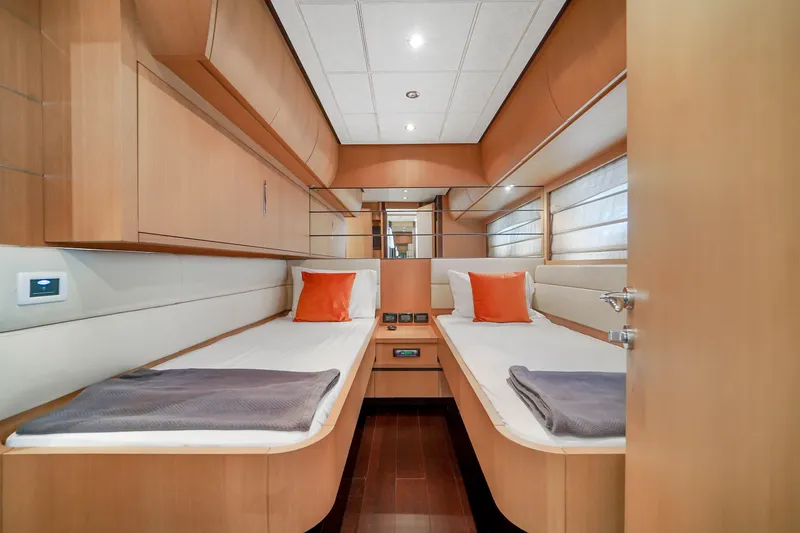 Slide: The Image of 2007 Pershing 90 yacht twin cabin with modern wood finish and orange accents. - 48