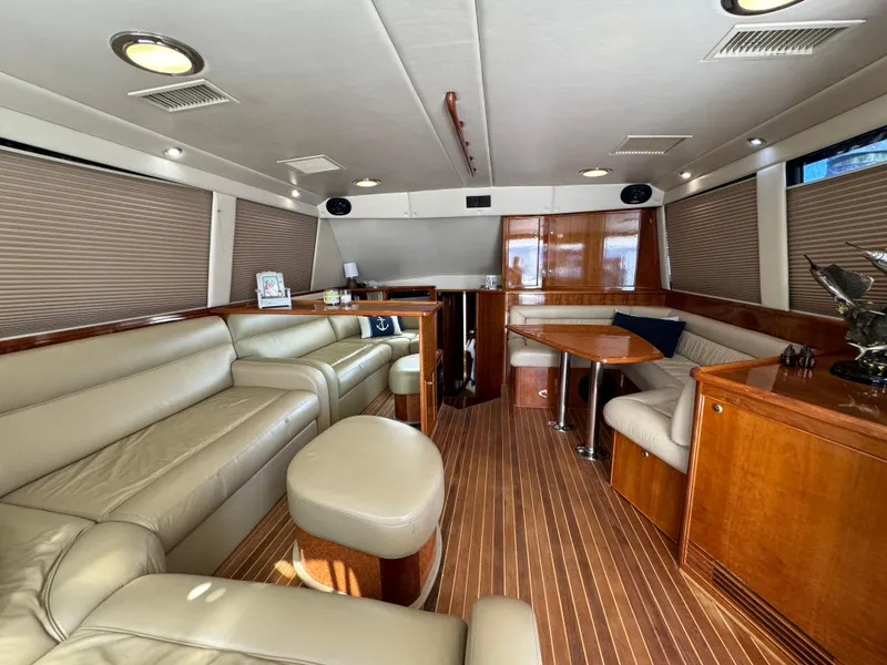 Slide: The Image of Luxurious 2003 Riviera 48 yacht interior with leather seating and wooden accents. - 11