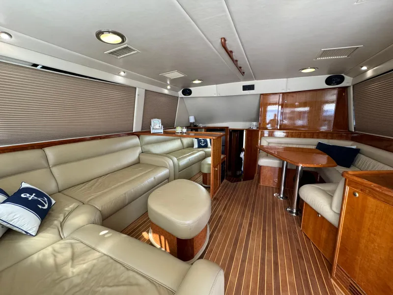 Slide: The Image of Luxurious interior of 2003 Riviera 48 yacht with leather seating and wooden accents. - 13