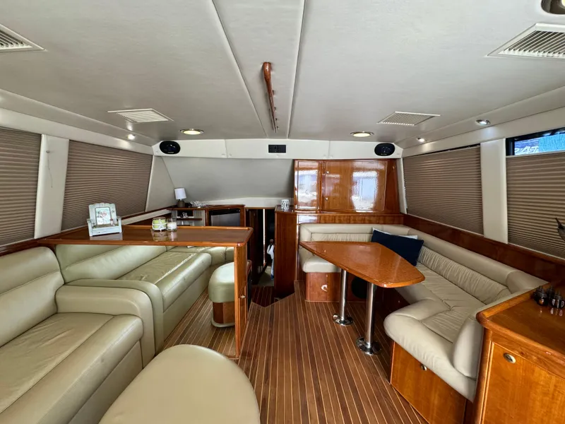 Slide: The Image of Luxurious interior of 2003 Riviera 48 yacht with leather seating and wooden finishes. - 14