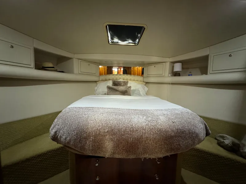 Slide: The Image of Luxurious bedroom interior of 2003 Riviera 48 yacht with cozy bedding and ambient lighting. - 18