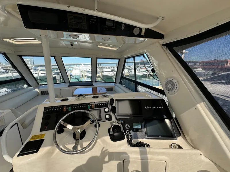 Slide: The Image of Interior view of 2003 Riviera 48 yacht helm with steering wheel and navigation equipment. - 23
