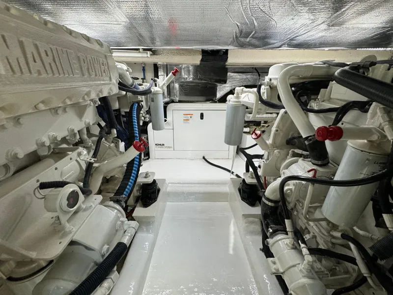 Slide: The Image of Engine room of 2003 Riviera 48 yacht, featuring dual marine power engines. - 27