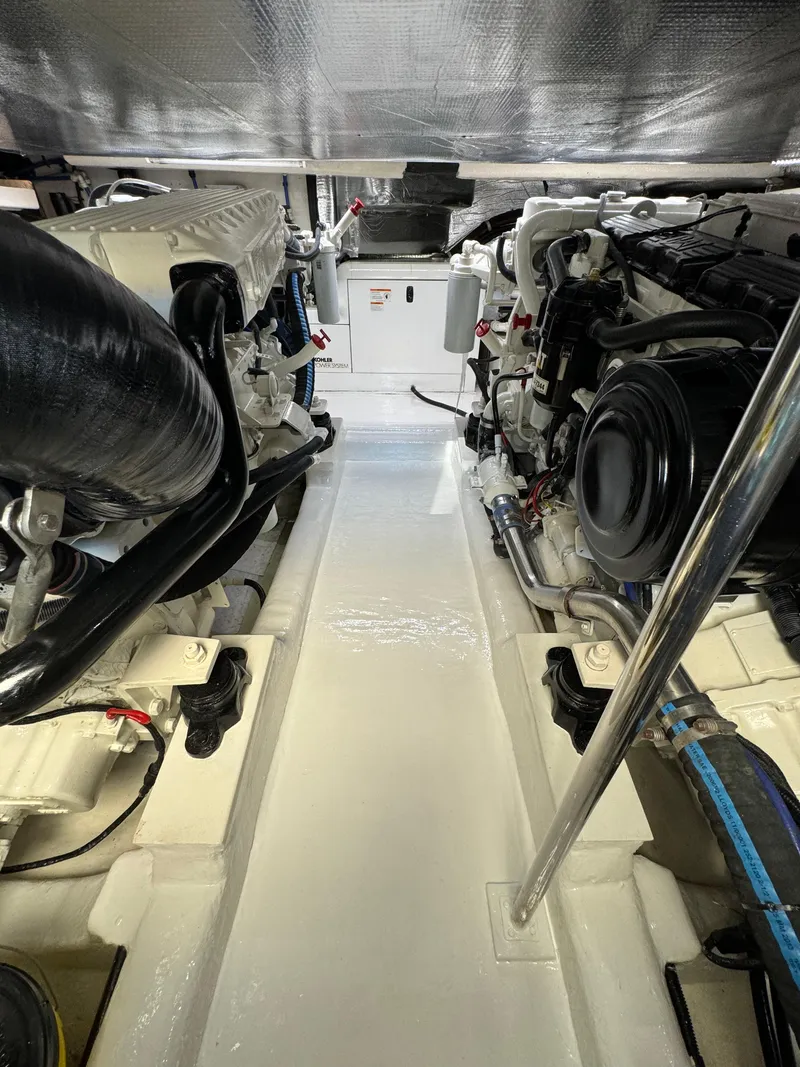 Slide: The Image of Engine room of 2003 Riviera 48 yacht, showcasing clean and organized machinery layout. - 28