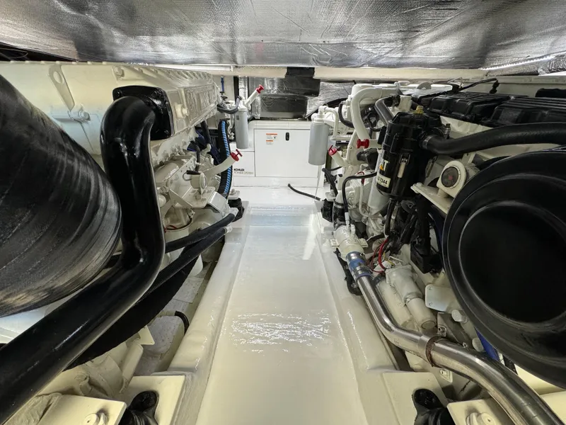 Slide: The Image of Engine room of 2003 Riviera 48 yacht, showcasing dual engines and mechanical components. - 29
